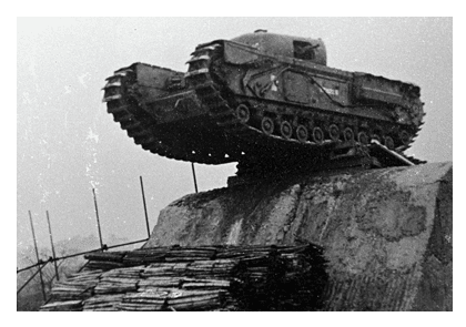 After breaching an obstacle using an SBG, this Churchill is about to drop on the other side cushioned by a previously laid fascine
