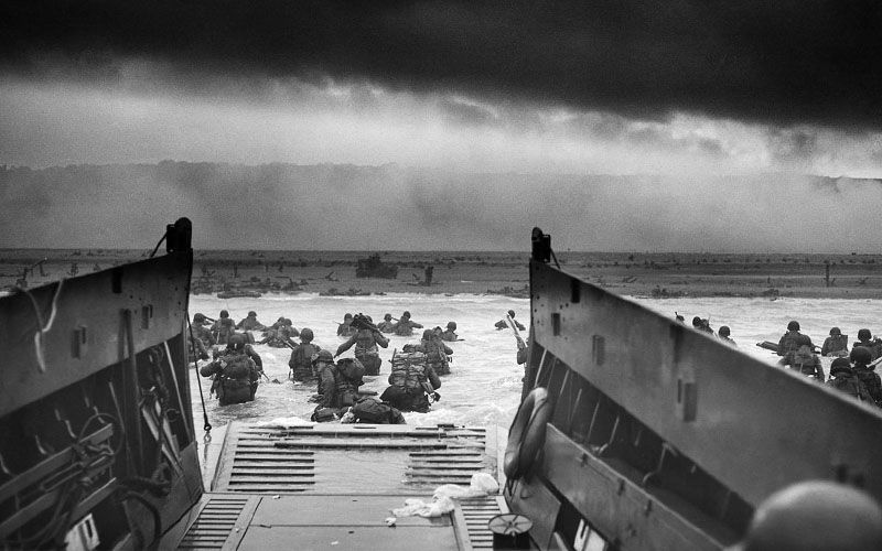 Coxswain's view from an LCVP, with American troops wading ashore in Normandy