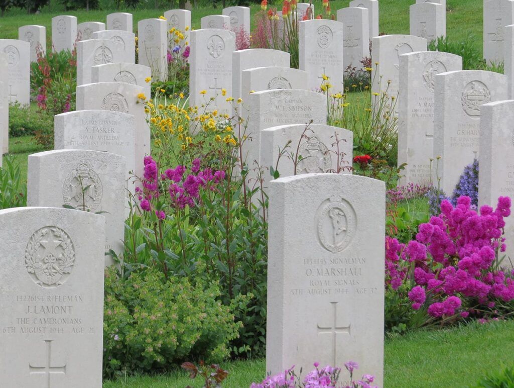 Flowers And Headstones At Brouay War Cemetery